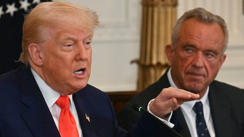 US President Donald Trump speaks as US Secretary of Health and Human Services Robert F. Kennedy Jr. looks on during a MAHA (Make America Healthy Again) Commission Event in the White House in Washington, DC, on May 22, 2025. (Photo by Jim WATSON / AFP) (Photo by JIM WATSON/AFP via Getty Images)