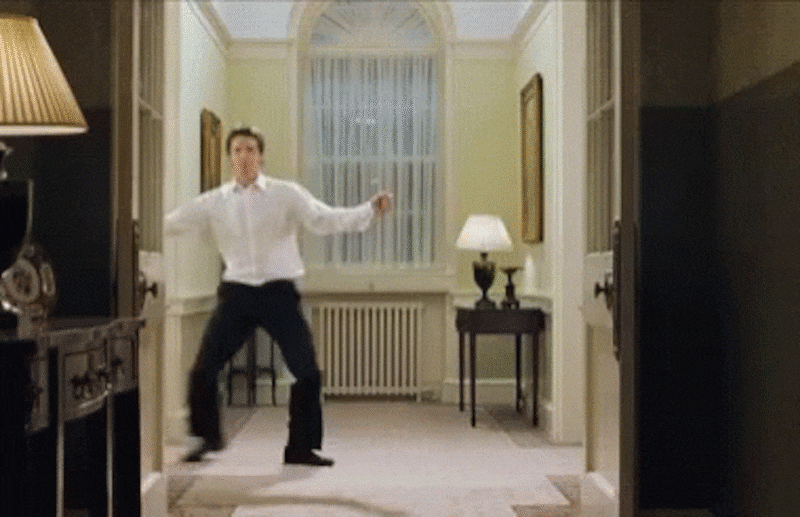 gif of Hugh Grant dancing in the hall in a scene from 'Love Actually'
