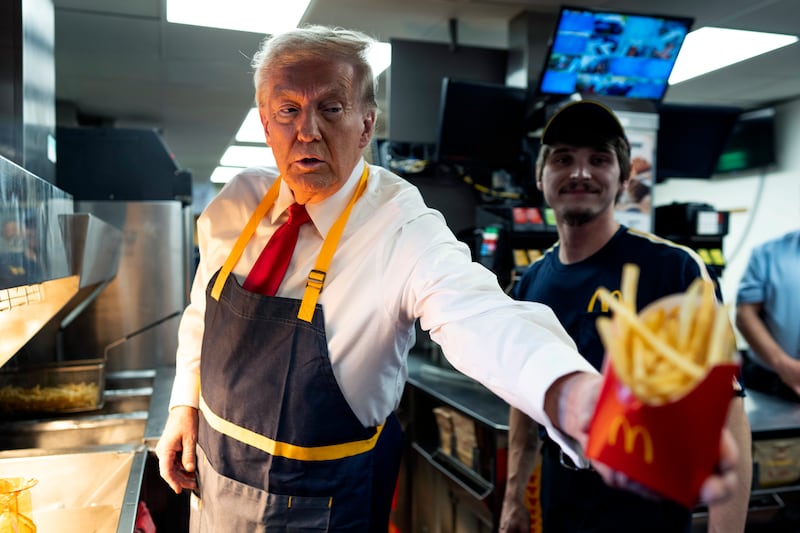 President Donald Trump works behind the counter at McDonald's.