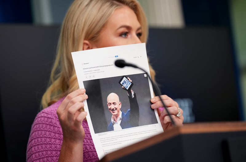White House press secretary Karoline Leavitt holds a news article on Amazon CEO Jeff Bezos as she slams Amazon at a White House briefing on April 29, 2025.