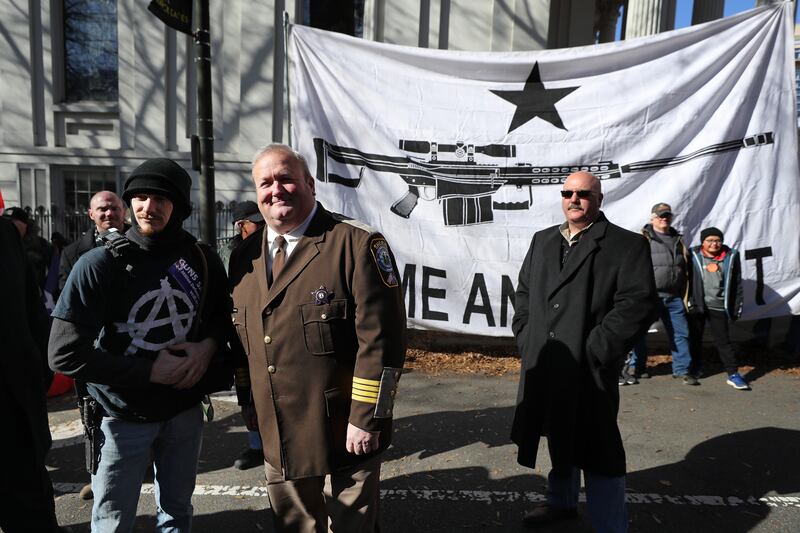 RICHMOND, VIRGINIA - JANUARY 20: Culpeper County, Virginia, Sheriff Scott Jenkins poses for photographs following a gun rights rally organized by The Virginia Citizens Defense League near the State Capitol Building January 20, 2020 in Richmond, Virginia. Jenkins has promised to deputize thousands of his county's gun owners if Democrats pass more restrictive gun laws. During elections last year, Virginia Governor Ralph Northam promised to enact sweeping gun control laws in 2020, including limiting handgun purchase to one per month, banning military-style weapons and silencers, allowing localities to ban guns in public spaces and enacting a 'red flag' law so authorities can temporarily seize weapons from someone deemed a threat. While event organizers have asked supporters to show up un-armed, militias and other extremist groups from across the country plan to attend the rally and show their support for gun rights. (Photo by Chip Somodevilla/Getty Images)
