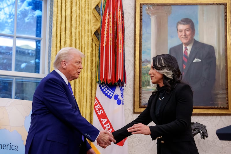 Tulsi Gabbard shakes hands with U.S. President Donald Trump in the Oval Office at the White House on February 12, 2025 in Washington, DC.