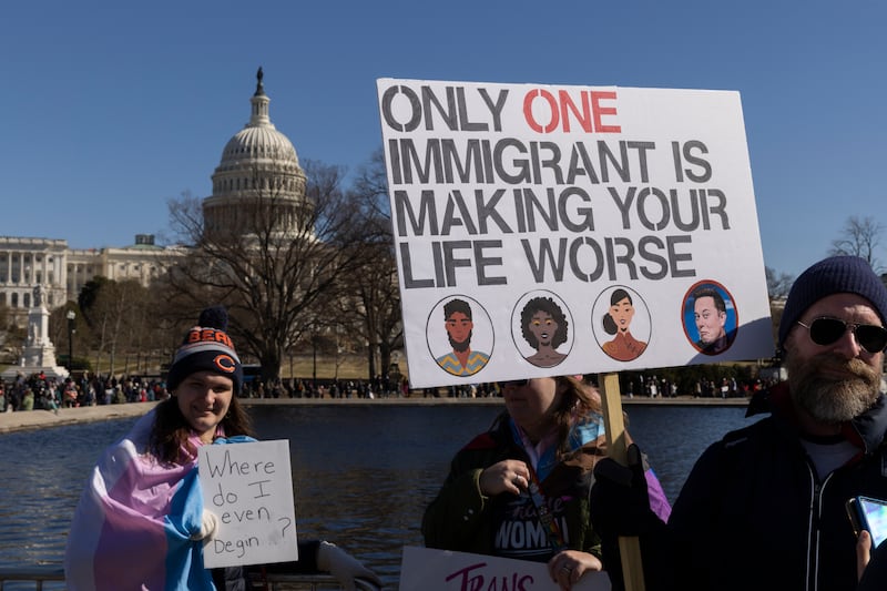 Protesters hold signs during ''Not My President's Day'' protests at the Capitol in Washington, D.C. on February 17, 2025.