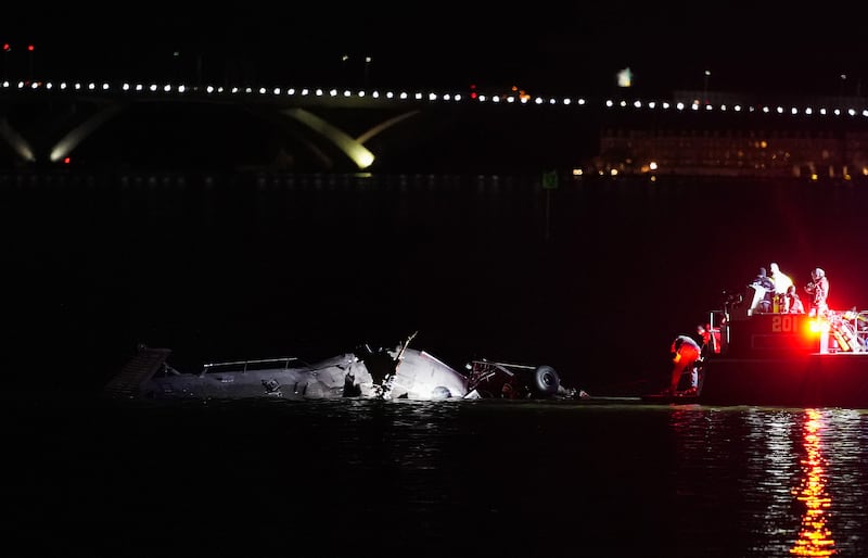 Emergency response units assess helicopter wreckage in the Potomac River near Ronald Reagan Washington Airport on January 30, 2025 in Arlington, Virginia.