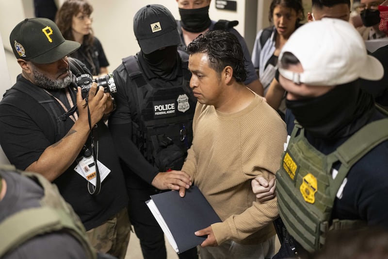 Federal agents detain a person after attending a court hearing at immigration court at the Jacob K. Javitz Federal Building in New York City, New York, U.S., July 1, 2025.