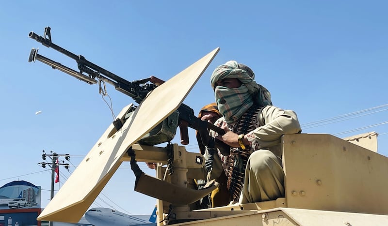 Taliban members are seen near Hamid Karzai International Airport as thousands of Afghans rush to flee the Afghan capital of Kabul, Afghanistan, on August 16, 2021. (Photo by Haroon Sabawoon/Anadolu Agency via Getty Images)