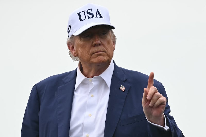 Trump steps off the plane.