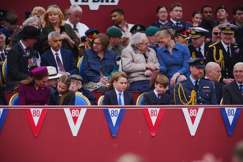 Prince Louis sticks out his tongue while seated alongside Kate Middleton, Princess Charlotte, Prince George, and Prince William Prince William.