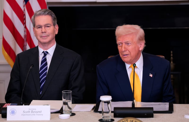 Donald Trump (R) speaks alongside Treasury Secretary Scott Bessent.