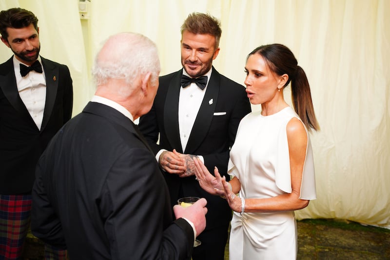 TETBURY, ENGLAND - FEBRUARY 07: King Charles III speaks to David Beckham and Victoria Beckham during a dinner in celebration of Slow Food at King Charles III's Gloucestershire estate, Highgrove Gardens on February 7, 2025 inTetbury, England. The King and Queen will join Hollywood star Stanley Tucci for a black tie dinner to celebrate Italian cuisine at Highgrove on Friday evening. The pair have invited the Italian-American Devil Wears Prada actor and well-known foodie and the Italian ambassador to the UK, Inigo Lambertini, to his Gloucestershire estate to enjoy a feast of sustainable Slow Food. (Photo by Ben Birchall - WPA Pool/Getty Images)