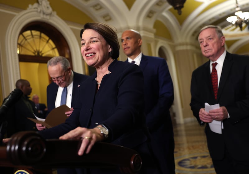 Amy Klobuchar (D-MN) speaks alongside Senate Majority Leader Charles Schumer (D-NY), Sen. Cory Booker (D-NJ) and Sen. Dick Durbin (D-IL). Durbin's departure will reshuffle party leadership.