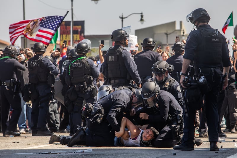 Los Angeles Police Department officers arrest a protester in front of the LA Federal Building on June 08, 2025 in Los Angeles, California.