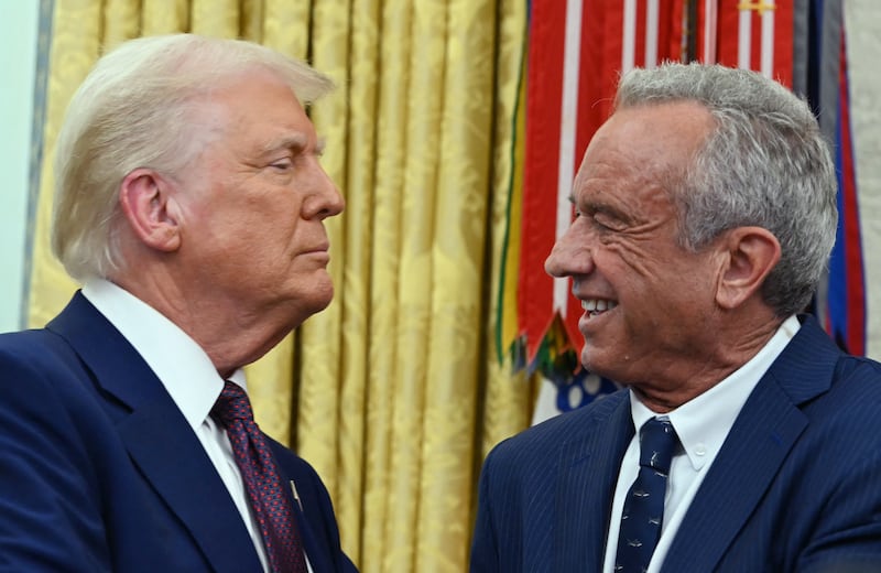US Secretary of Health and Human Services Robert F. Kennedy Jr., shakes hands with US President Donald Trump.