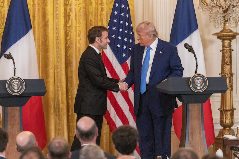 U.S. President Donald Trump shakes hands with French President Emmanuel Macron at a joint press conference at the White House in Washington, D.C., the United States, on Feb. 24, 2025.
