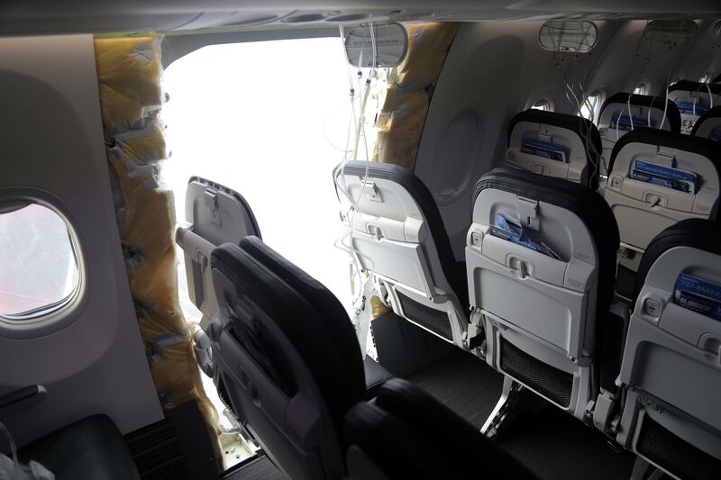 An Alaska Airlines 737 MAX missing a door panel.
