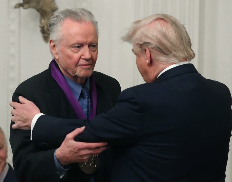 U.S. President Donald Trump (R) presents actor Jon Voight with the National Medal of Arts during a ceremony in the East Room of the Whit House on November 21, 2019 in Washington, DC.