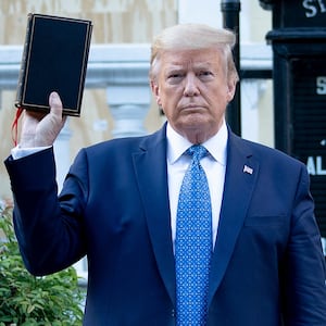 Donal Trump holds Bible