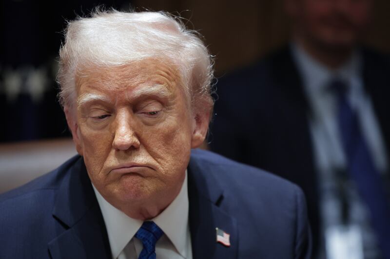 U.S. President Donald Trump listens to a reporter's question during an Ambassador Meeting in the Cabinet Room of the White House on March 25, 2025 in Washington, DC.