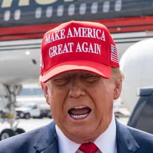 Former U.S. President Donald Trump speaks to the media as he arrives at the Atlanta Airport.