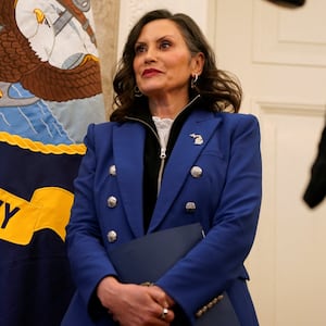 Michigan Governor Gretchen Whitmer stands, as U.S. President Donald Trump (not pictured) signs executive orders and proclamations, in the Oval Office at the White House in Washington, D.C., U.S., April 9, 2025. REUTERS/Nathan Howard