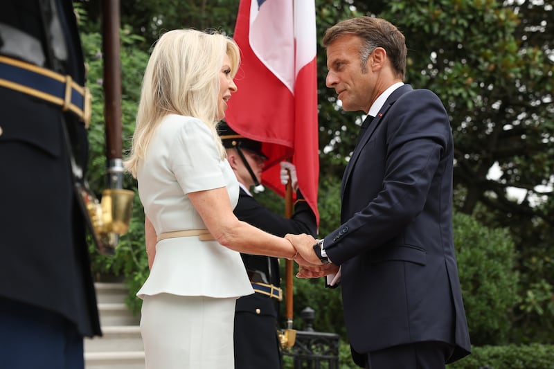 French President Emmanuel Macron was greeted by U.S. Chief of Protocol Monica Crowley as he arrives at the White House for a meeting with U.S. President Donald Trump and Ukrainian President Volodymyr Zelensky on August 18, 2025 in Washington, DC. President Trump is hosting President Zelensky at the White House for a bilateral meeting and later an expanded meeting with European leaders to discuss a peace deal between Russia and Ukraine.