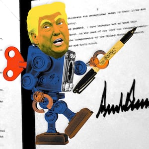 Robot Donald Trump with a gold foil on top of a signed executive order