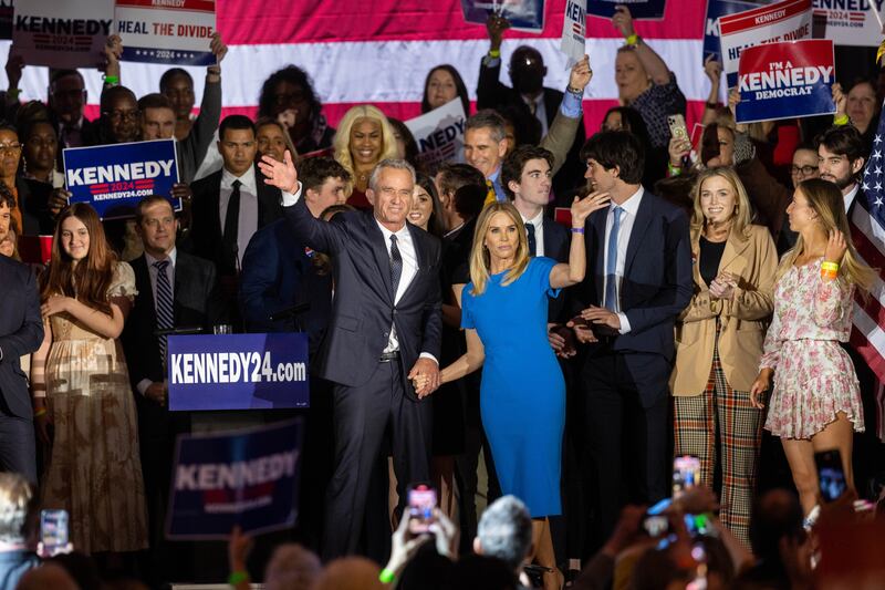 BOSTON, MA - APRIL 19: Robert F. Kennedy Jr. and his wife Actress Cheryl Hines wave to supporters on stage after announcing his candidacy for President on April 19, 2023 in Boston, Massachusetts. An outspoken anti-vaccine activist, RFK Jr. joins self-help author Marianne Williamson in the Democratic presidential field of challengers for 2024.