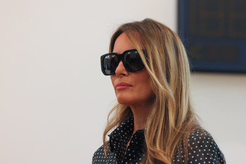 Former U.S. first lady Melania Trump looks on as Republican presidential nominee and former U.S. President Donald Trump (not pictured) speaks to reporters after voting at Mandel Recreation Center on Election Day in Palm Beach, Florida, U.S., November 5, 2024.