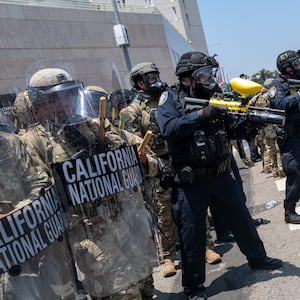 The National Guard, police and protesters stand off outside of a downtown jail in Los Angeles.