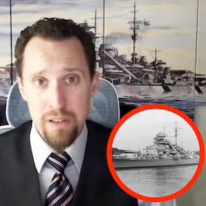 EJ Antoni in front of a mural reportedly showing The German Battleship Bismarck in 1940 with an inset image of the Bismarck