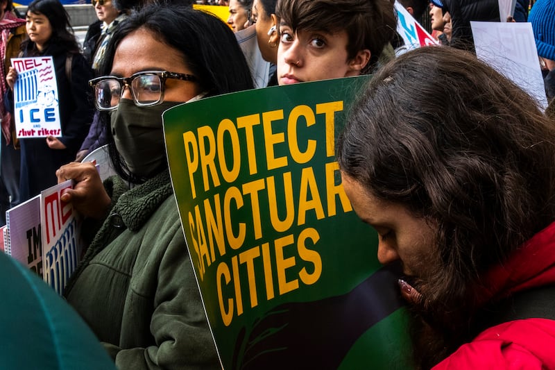 A person holds a sig reading "protect sanctuary cities"  during a protest against the opening of an ICE office at Rikers prison island on April 10, 2025 in New York City.