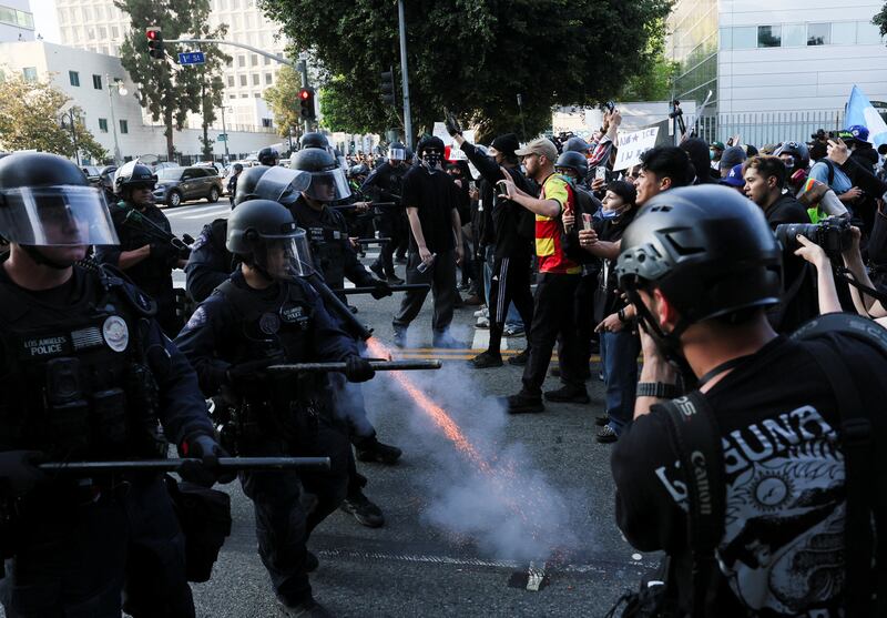 A police officer fires a crowd control munition into the ground while confronting demonstrators, during protests against federal immigration sweeps, in Los Angeles, California, U.S. June 9, 2025.