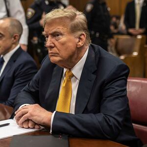 Donald Trump sits in a courtroom between his lawyers Emil Bove and Todd Blanche.