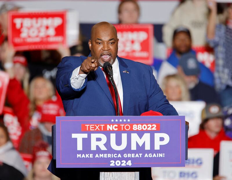Mark Robinson speaks on stage at a Donald Trump rally.