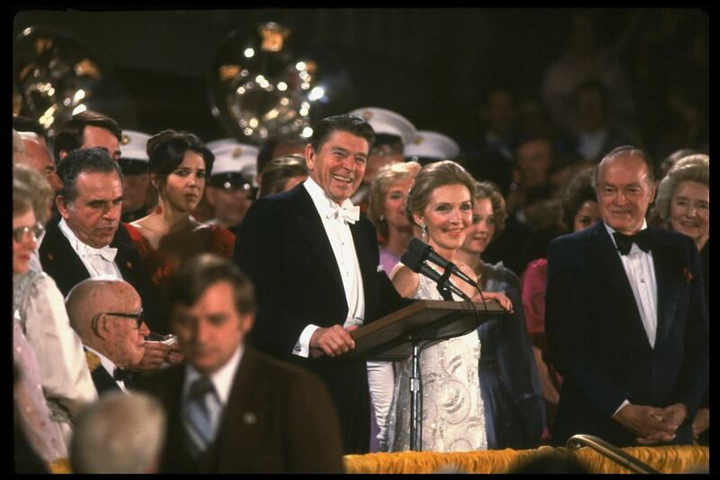 Pres. and Nancy Reagan at podium at inaugural gala, Kennedy Center; Bob Hope & wife (L) Patti Reagan (in red, R) Omar Bradley (1893 - 1981), lower right.