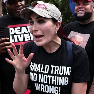Laura Loomer, far-right activist, speaks with anti-Trump demonstrators near the entrance of the Fulton County Jail, as former U.S. President Donald Trump is expected to turn himself in to be processed after his Georgia indictment, in Atlanta, Georgia, U.S., August 24, 2023. REUTERS/Dustin Chambers