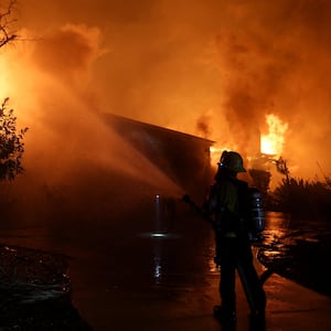 A firefighter works to extinguish flames as the Eaton Fire burns in Pasadena, California, U.S. January 8, 2025.
