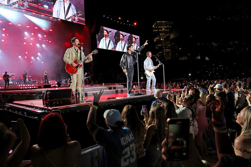 Nick Jonas, Joe Jonas, and Kevin Jonas perform during Jonas Brothers “Five Albums, One Night” Tour in NYC.