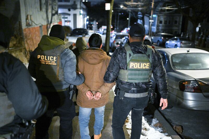 NEW YORK, NY - JANUARY 28: Law enforcement walk with Leonardo Fabian Cando Juntamay as he was detained in the Bronx during ICE led operations to apprehend illegal immigrants on Tuesday January 28, 2025 in New York, NY.