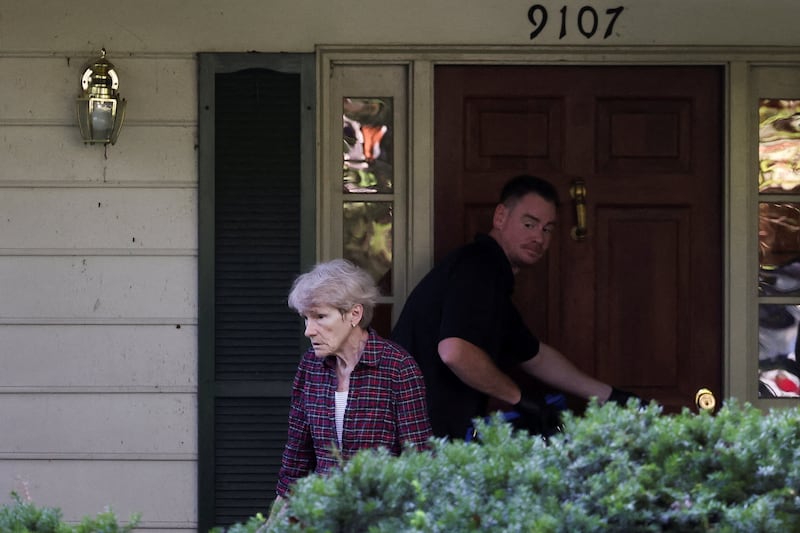 Gretchen Smith Bolton, wife of the former White House national security adviser John Bolton, stands in front of Bolton's house as it is searched by FBI members, in Bethesda, MD on August 22, 2025.