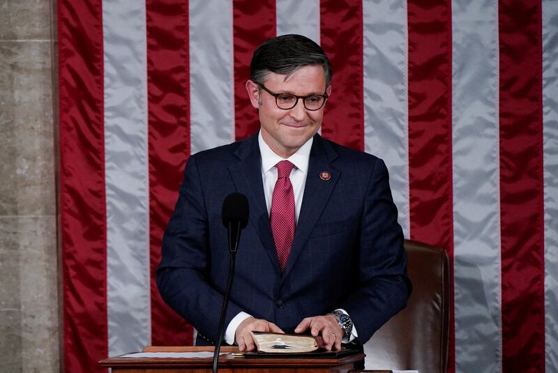 Speaker Mike Johnson (R-LA) smiles as he reacts to the applause of members of the House after being elected to be the new Speaker.