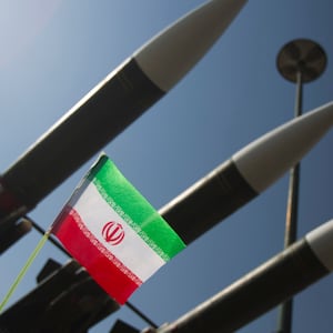 An Iranian flag is pictured next to Russian-made Sam-6 surface-to-air missiles during a war exhibition held by Iran's revolutionary guard to mark the anniversary of the Iran-Iraq war (1980-88), also known in Iran as the "Holy Defence", at Baharestan square near the Iranian Parliament in southern Tehran September 25, 2010. REUTERS/Morteza Nikoubazl (IRAN - Tags: ANNIVERSARY MILITARY POLITICS IMAGES OF THE DAY)