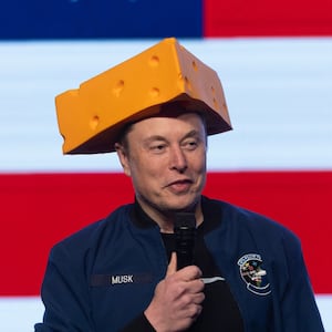 GREEN BAY, WISCONSIN - MARCH 30: Billionaire businessman Elon Musk arrives for a town hall wearing a cheesehead hat at the KI Convention Center on March 30, 2025 in Green Bay, Wisconsin. The town hall is being held in front of the state’s high-profile Supreme Court election between Circuit Court Judge Brad Schimel, who has been financially backed by Musk and endorsed by President Donald Trump, and Dane County Circuit Court Judge Susan Crawford. (Photo by Scott Olson/Getty Images)