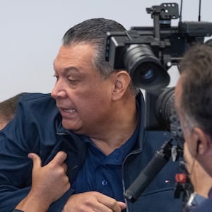California Senator Alex Padilla is pushed out of the room as Homeland Security Secretary Kristi Noem holds a news conference in Los Angeles on Thursday, June 12, 2025.