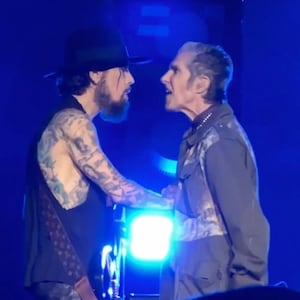 Jane’s Addiction frontman Perry Farrell punches guitarist Dave Navarro at their Boston concert.