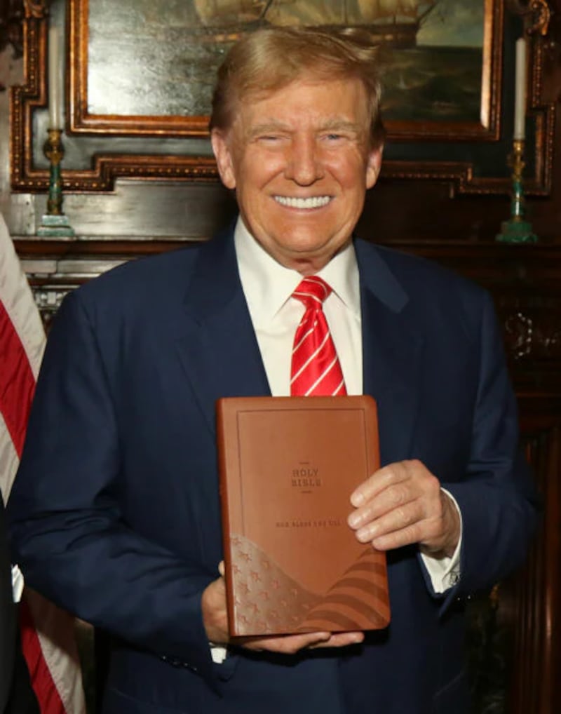 Trump with his "God Bless The USA Bible."