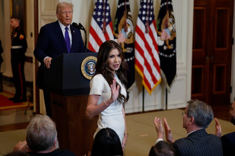 Homeland Security Secretary Kristi Noem stands while being acknowledged by U.S. President Donald Trump during the signing ceremony for the Laken Riley Act in the East Room of the White House on January 29, 2025 in Washington, DC. (Photo by Chip Somodevilla/Getty Images)
