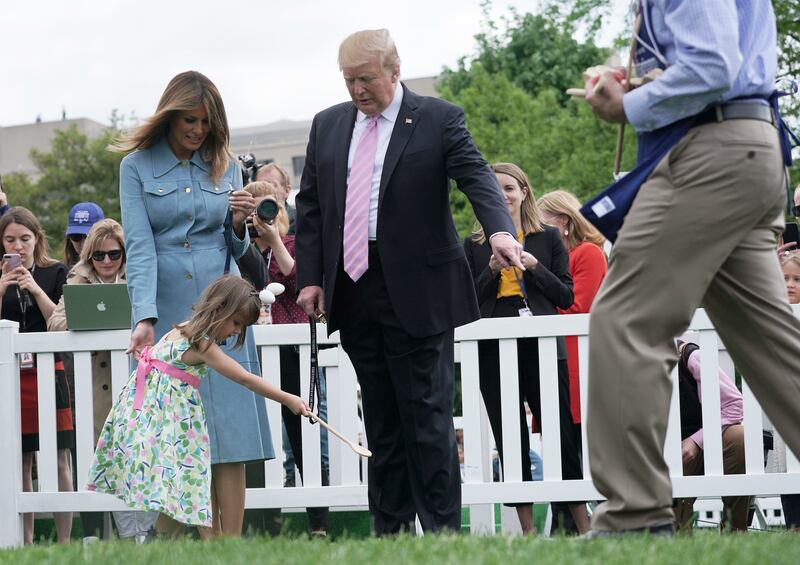 President Donald Trump and First Lady Melania Trump watch children participating in the 141st Easter Egg Roll on the South Lawn of the White House in 2019.