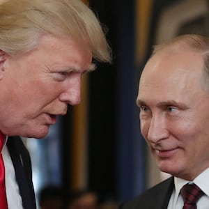 US President Donald Trump (L) chats with Russia's President Vladimir Putin as they attend the APEC Economic Leaders' Meeting, part of the Asia-Pacific Economic Cooperation (APEC) leaders' summit in the central Vietnamese city of Danang on November 11, 2017.