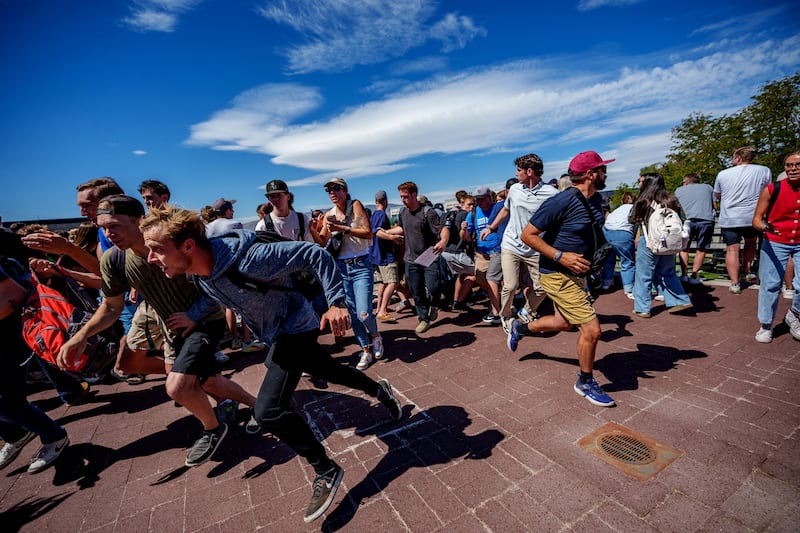 People run after a shot was fired at right-wing activist and commentator Charlie Kirk during a Utah Valley University speaking event in Orem, Utah, on Sept. 10, 2025.